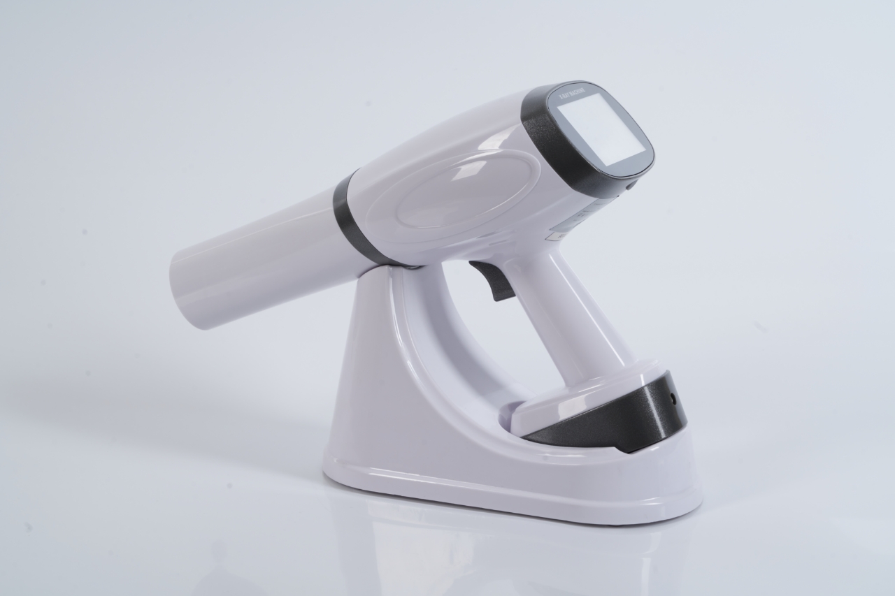 IDEN-X2 handheld dental X-ray unit with charging dock — touchscreen display visible