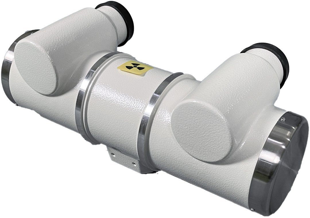 Photograph of the tube assembly in its housing: white shell, yellow radiation symbol and high-voltage sockets at both ends
