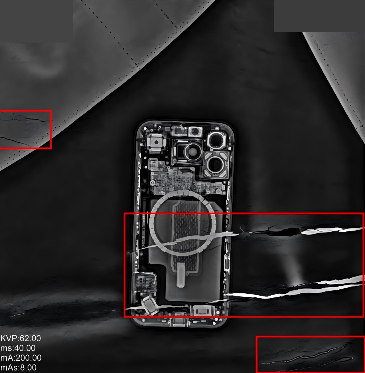 Radiograph of a lead apron with three cracks marked in red