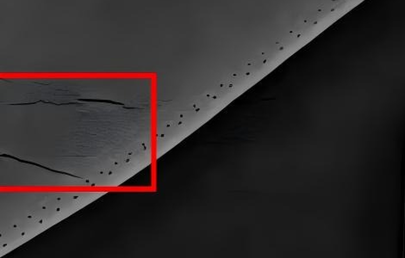 Enlarged crack region: several dark threads inside the red box, with fine crazing around them